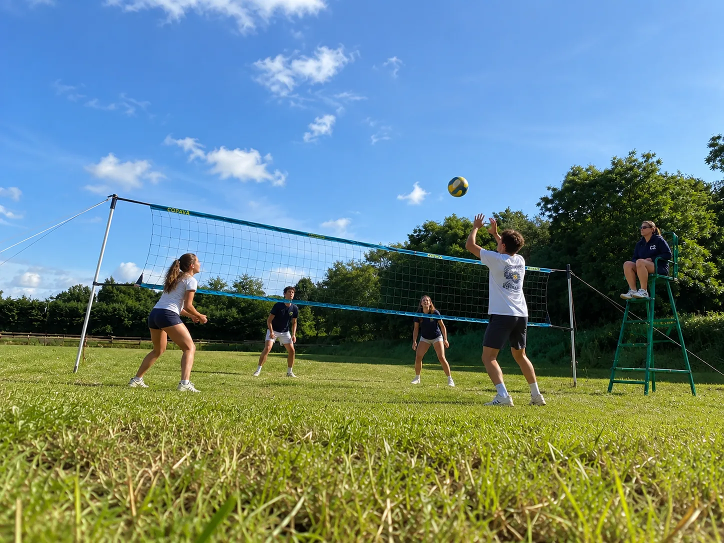 Teenagers playing volleyball on the C2 field