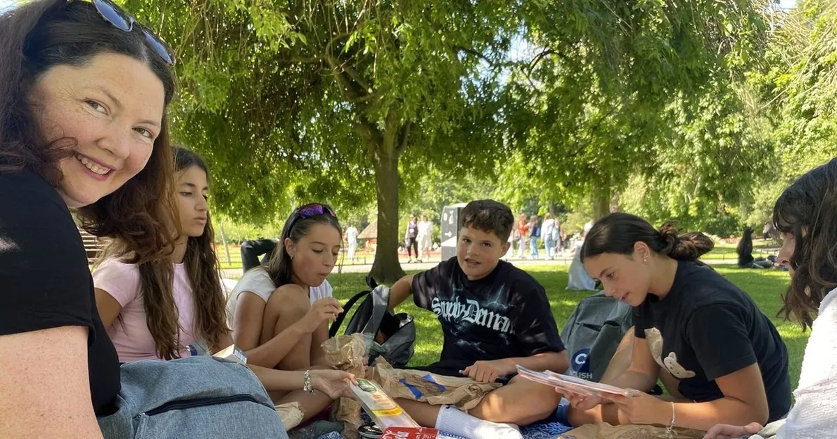 C2 students enjoying a picnic together in a park
