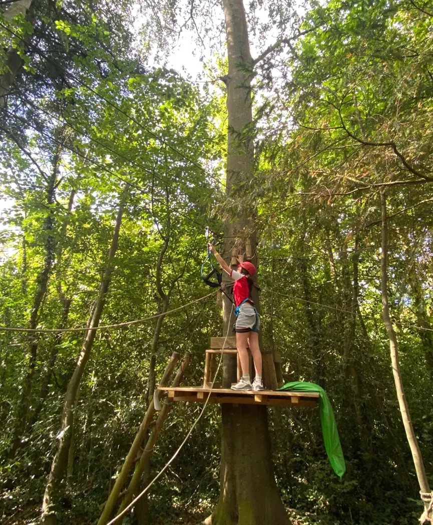 Student on a treetop ziplining adventure