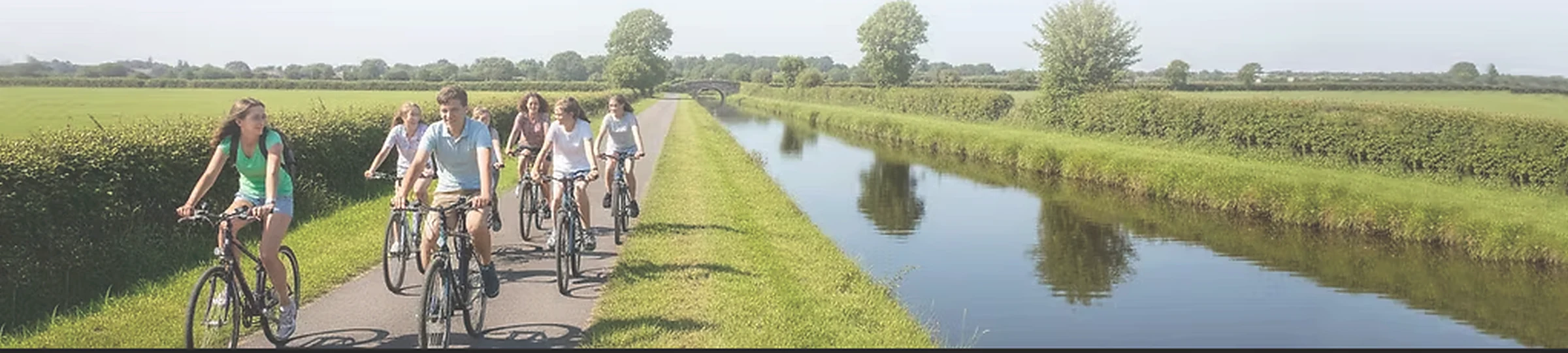 Teenagers cycling beside the Royal Canal