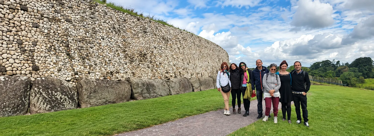 Adults exploring the ancient Newgrange monument in Ireland