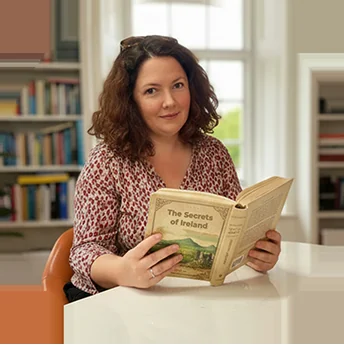 Maria Mangan, C2 English School Director of Studies, reading in the school library
