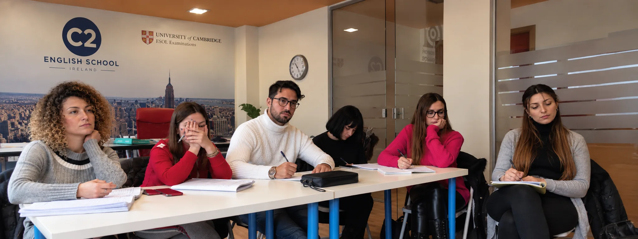 Adult students working on examination preparation in a C2 classroom